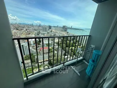 Stunning high-rise balcony with panoramic city and ocean views, perfect for urban living.