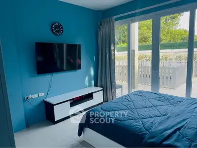Spacious bedroom with modern decor and large windows overlooking garden