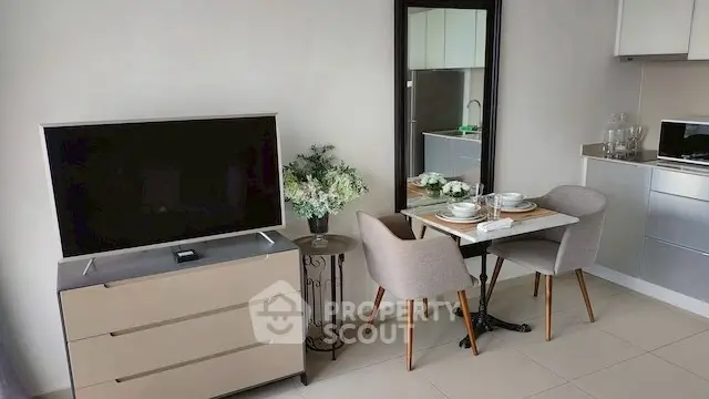 Modern living room with sleek TV, dining set, and elegant decor.