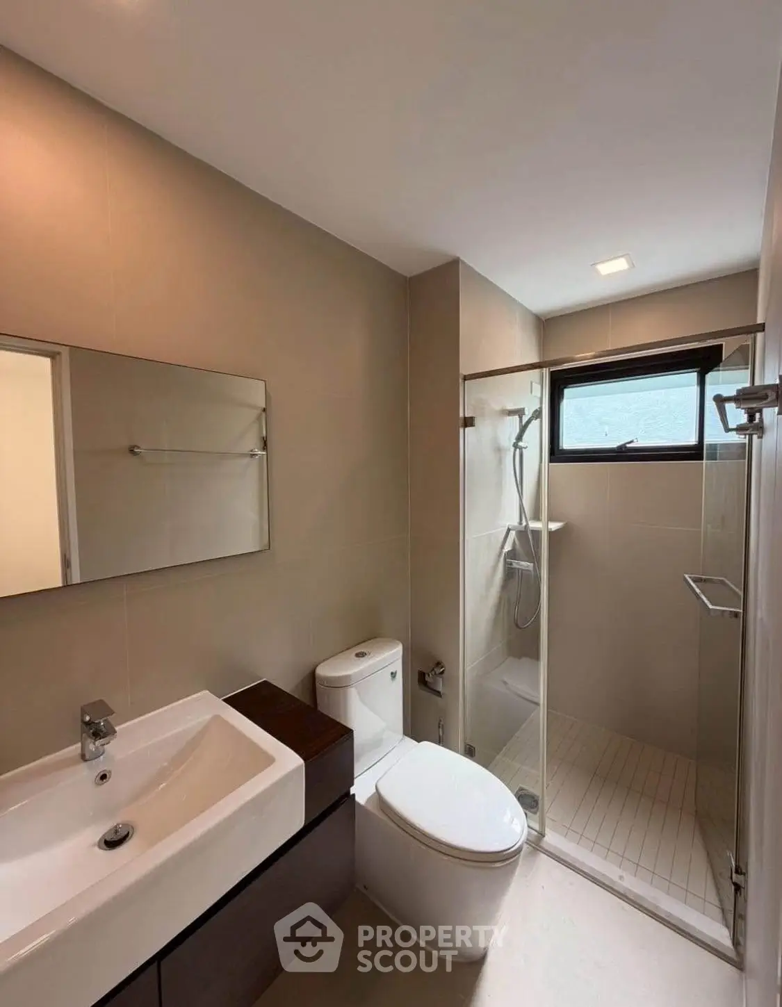 Modern bathroom with sleek fixtures and glass shower enclosure