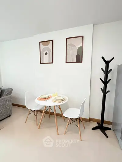 Modern dining area with stylish decor and minimalist furniture in a cozy living space.