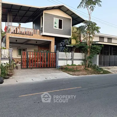 Modern two-story house with spacious balcony and stylish facade, perfect for family living.