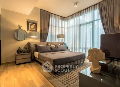 Luxurious bedroom with modern decor and large windows for natural light