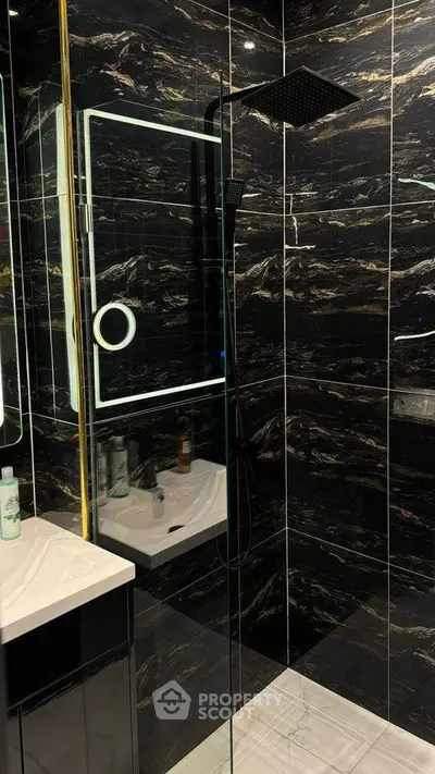 Luxurious black marble bathroom with modern shower and sleek design
