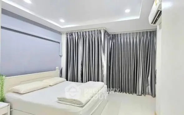 Modern bedroom with sleek design and elegant curtains