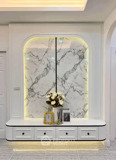 Elegant living room with marble accent wall and modern decor