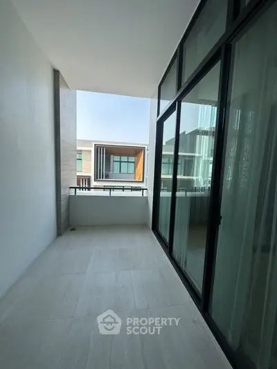Spacious balcony with modern design and large glass windows