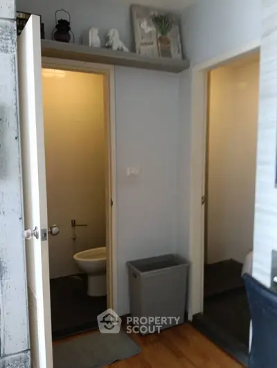 Compact bathroom with modern fixtures and wooden flooring