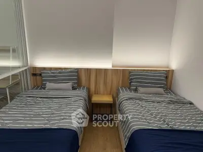 Modern twin bedroom with stylish wooden headboard and cozy bedding