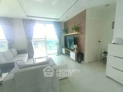 Bright and modern living room with large windows and stylish decor, perfect for relaxation and entertainment.