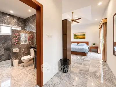 Luxurious bedroom with en-suite marble bathroom and elegant decor