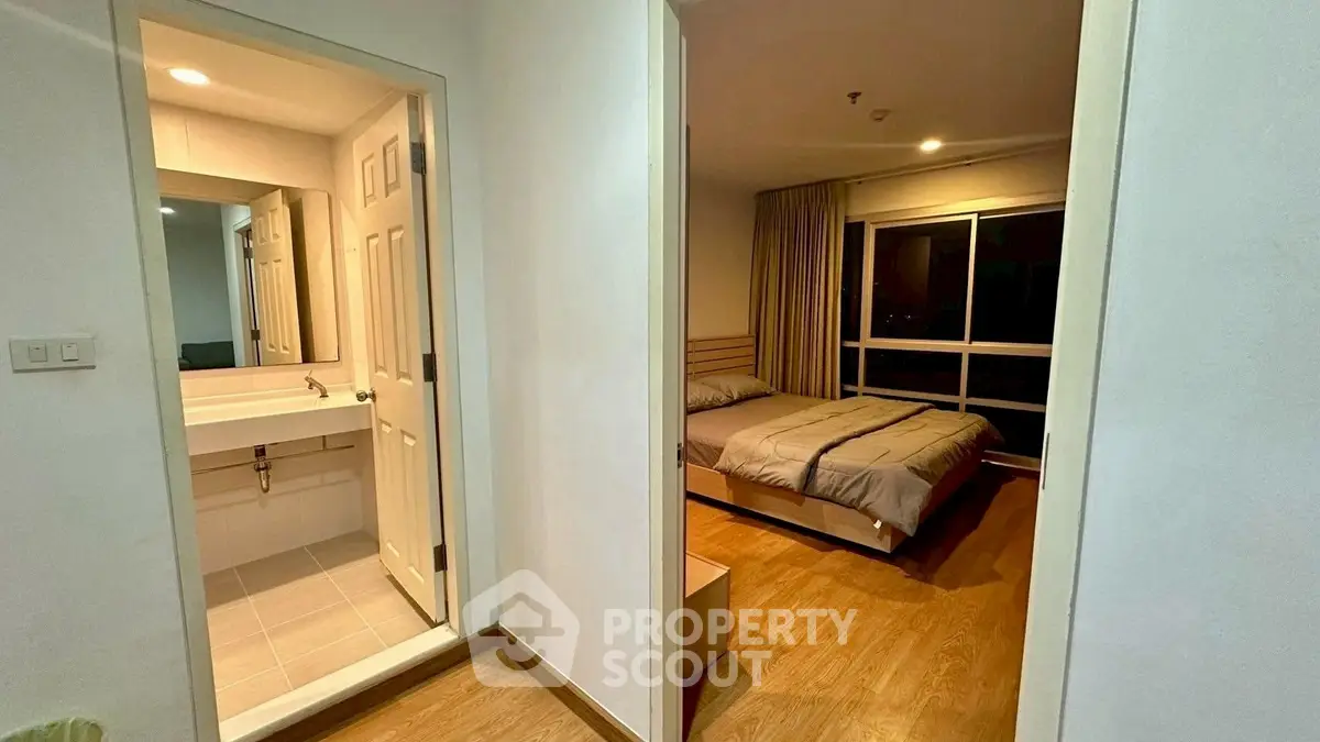 Modern apartment with cozy bedroom and sleek bathroom, perfect for urban living.