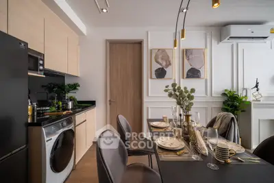 Modern kitchen and dining area with sleek appliances and elegant decor