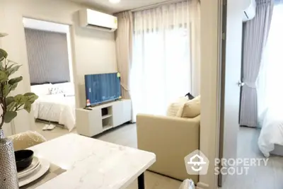 Modern apartment interior with open layout, featuring a cozy living area and stylish bedroom.