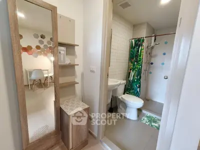 Modern apartment interior with bathroom and stylish decor, featuring a vibrant shower curtain and sleek furnishings.