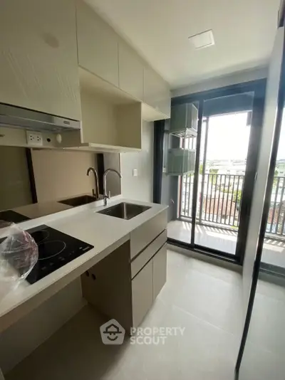Modern kitchen with sleek design and balcony view