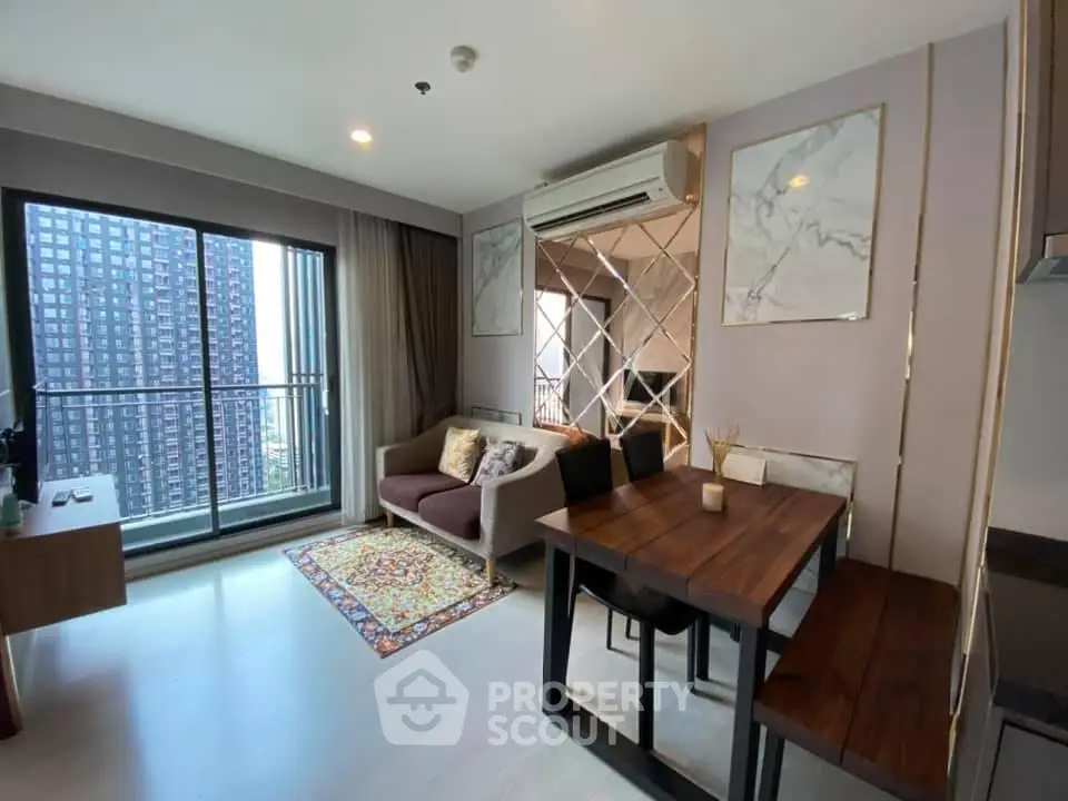 Modern living room with balcony view in a high-rise apartment, featuring stylish decor and ample natural light.