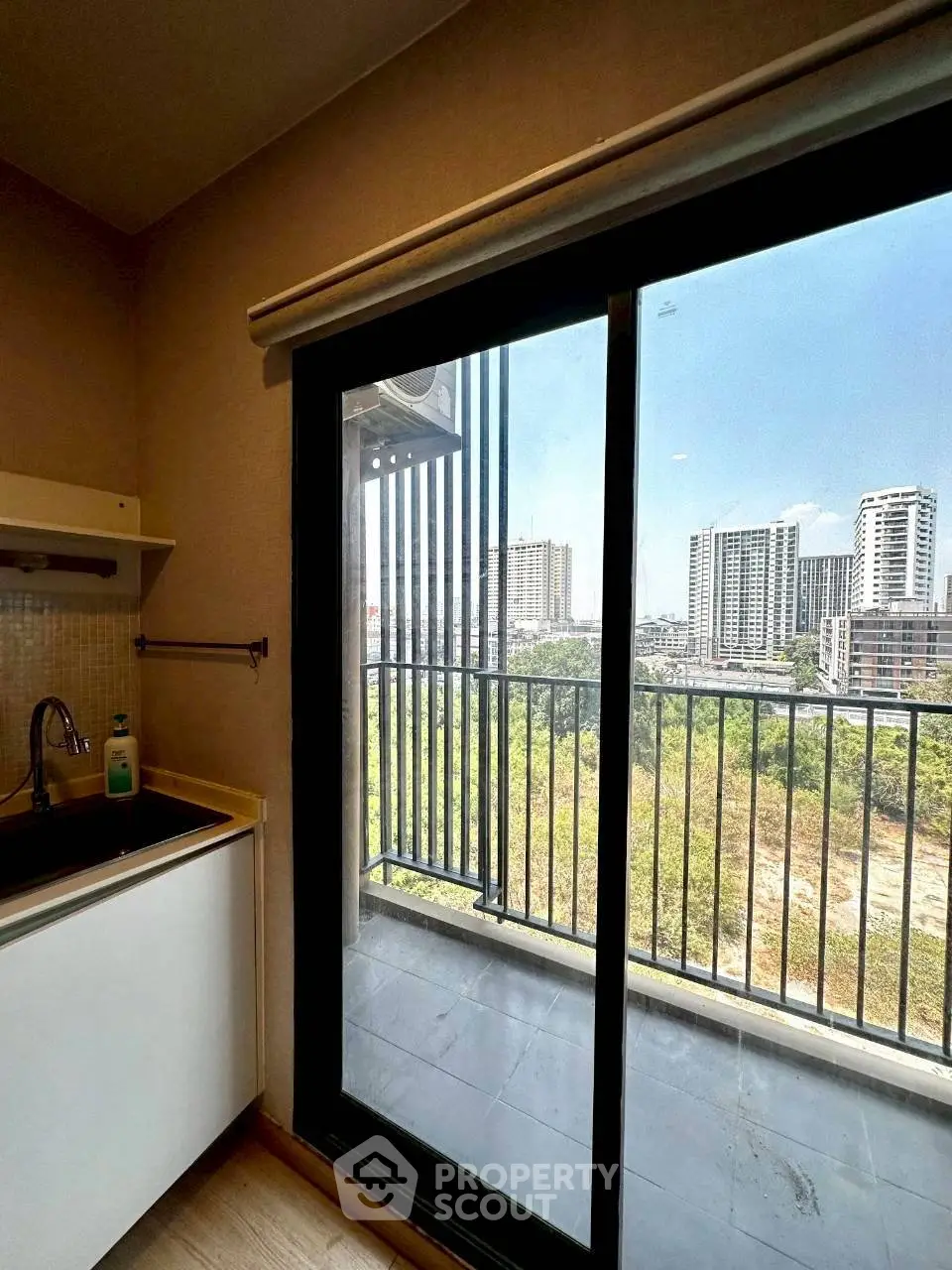 Modern kitchen with balcony view in urban apartment