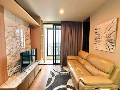 Modern living room with leather sofa and balcony view