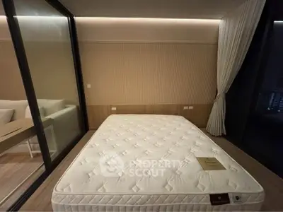 Modern bedroom with large glass window and minimalist decor, featuring a comfortable mattress and elegant lighting.