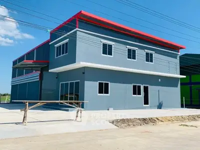 Modern industrial building with sleek design and ample outdoor space.