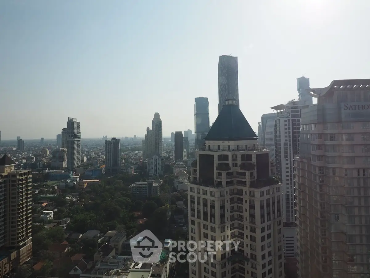 Stunning cityscape view from a high-rise building showcasing urban skyline and architectural diversity.