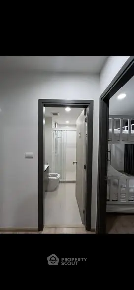 Modern apartment interior with bathroom and bunk bed view