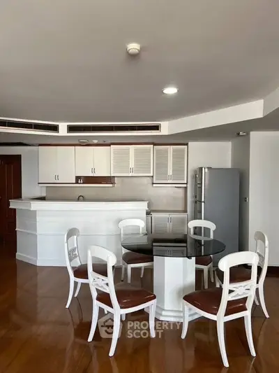 Spacious kitchen with elegant dining area and modern appliances in a stylish open layout.
