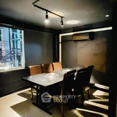 Modern dining area with sleek black decor and stylish lighting