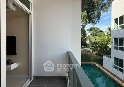 Charming balcony with pool view in modern apartment complex