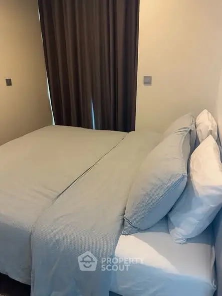 Cozy bedroom with elegant bedding and soft lighting, perfect for relaxation.