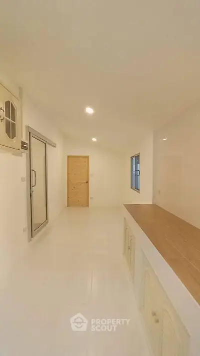 Spacious minimalist interior with wooden accents and ample natural light