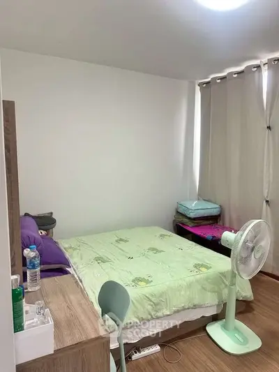 Cozy bedroom with modern decor and natural light, featuring a comfortable bed and stylish furnishings.