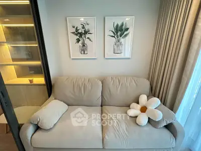 Cozy living room with beige sofa, floral decor, and soft lighting