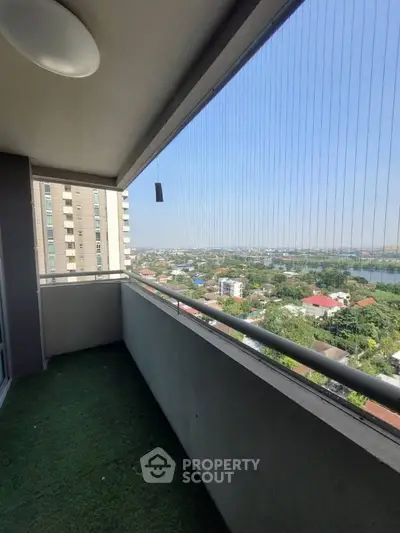 Spacious balcony with stunning city view in modern high-rise apartment