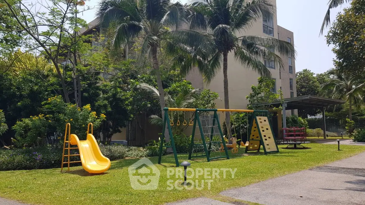 Lush garden with playground equipment in a residential complex