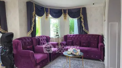 Luxurious living room with elegant purple velvet furniture and stylish drapery, perfect for sophisticated gatherings.