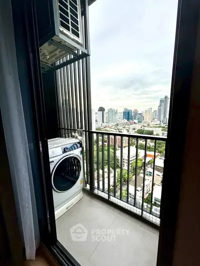 High-rise balcony with city view and washing machine, perfect urban living.
