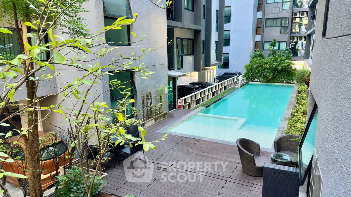 Modern apartment complex with pool and outdoor seating area