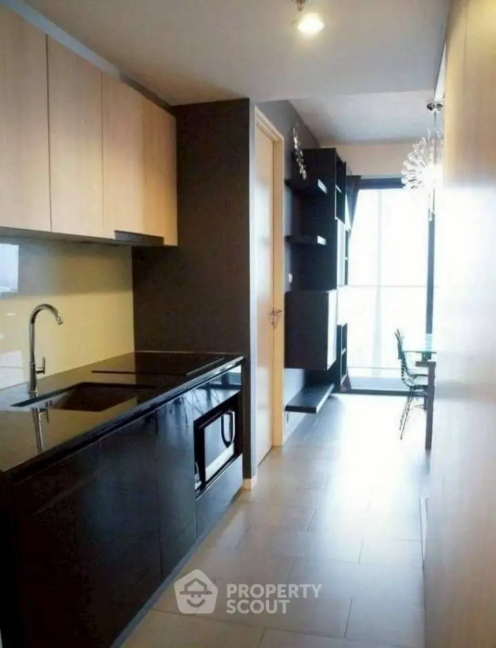 Modern kitchen with sleek black countertops and open layout design.