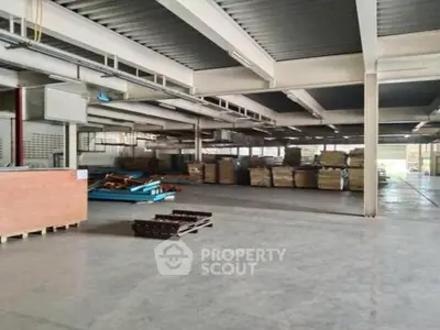 Expansive industrial warehouse space with high ceilings and ample storage capacity, ideal for large-scale operations and logistics.