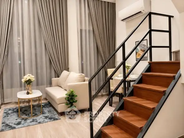 Modern living room with elegant staircase and cozy seating area