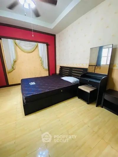 Spacious bedroom with modern decor and large mirror, perfect for relaxation.