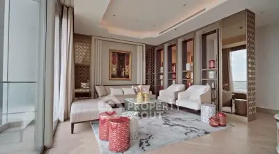 Luxurious living room with elegant decor and stunning city view, featuring modern furniture and artistic accents.