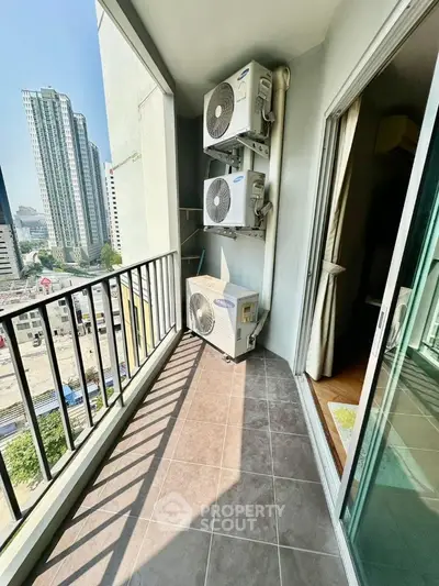 Spacious balcony with city view and air conditioning units in modern apartment