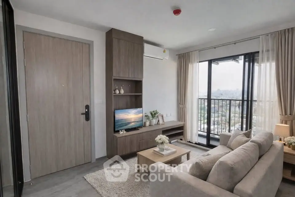 Modern living room with city view, cozy sofa, and stylish decor in a high-rise apartment.