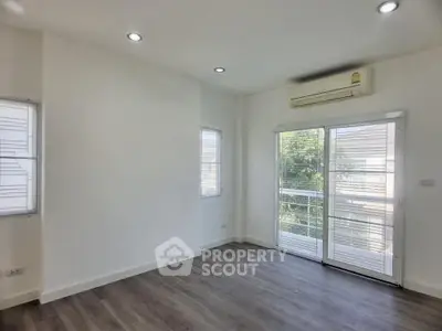 Spacious and bright living room with modern flooring, large windows, and a refreshing view, perfect for comfortable urban living.