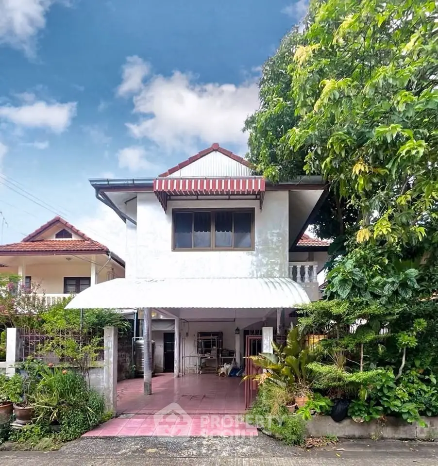 Charming two-story house with lush garden and covered carport in a serene neighborhood.