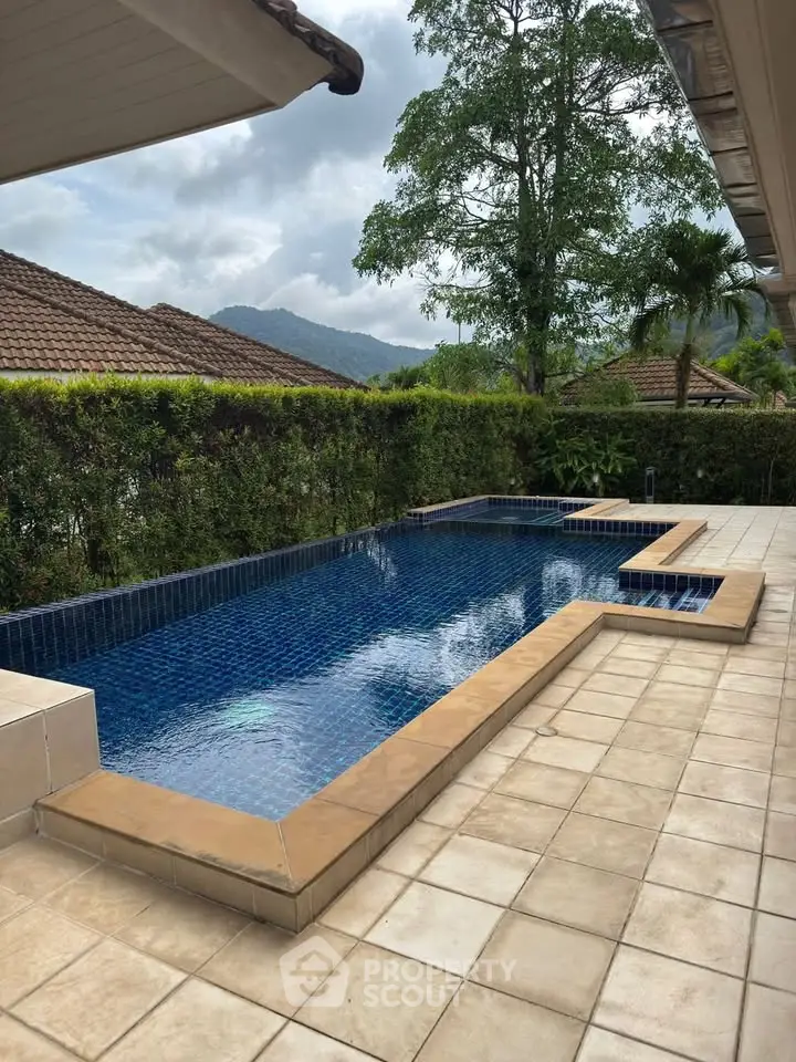 Stunning private pool with scenic mountain views and lush greenery, perfect for relaxation and entertainment.