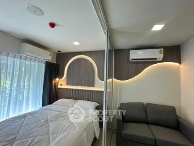 Modern bedroom with stylish lighting and cozy seating area